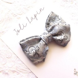 Crossed silver arabesque bow