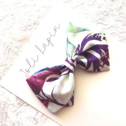 Crossed purple flowers bow
