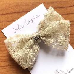 Crossed festive gold lace bow